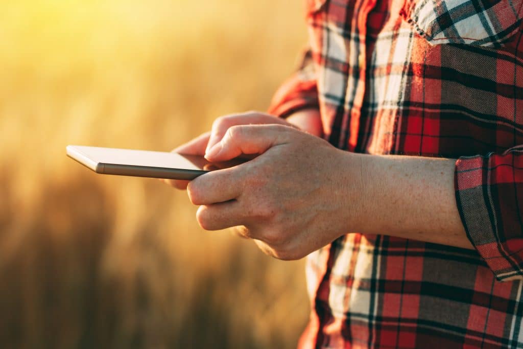 Un agricultor control desde su tableta los datos referentes a los cultivos para aumentar su productividad en el campo.